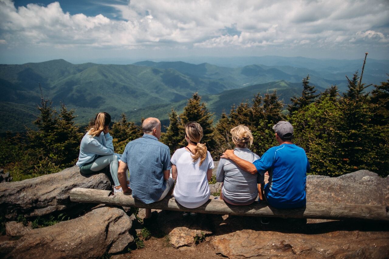 A family sitting together on a mountain overlook