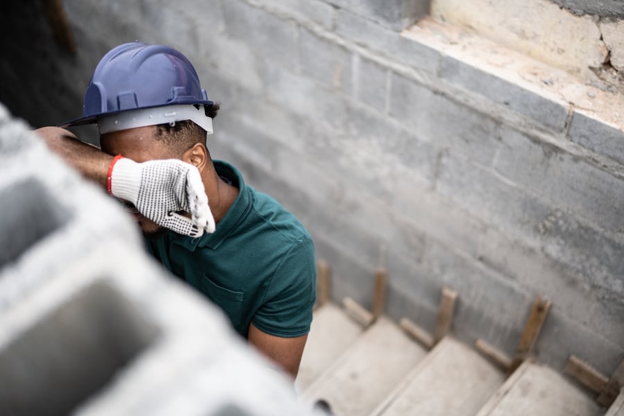 A worker in a hard hat taking a quiet moment